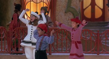 Movie still from “The Santa Clause 2” (2002), directed by Michael Lembeck – A group of children performing a dance on a stage; Medium shot, Low angle