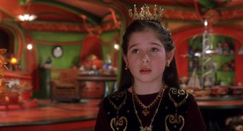 Movie still from “The Santa Clause 2” (2002), directed by Michael Lembeck – A little girl wearing a crown and a necklace; Close Up shot, High angle