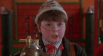 Movie still from “The Santa Clause 2” (2002), directed by Michael Lembeck – A young boy wearing glasses and a hat; Close Up shot, Over the shoulder angle
