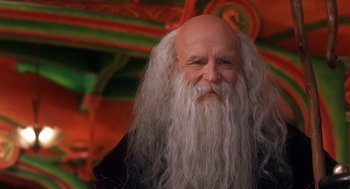 Movie still from “The Santa Clause 2” (2002), directed by Michael Lembeck – An old man with long white hair and a long beard; Close Up shot, Low angle