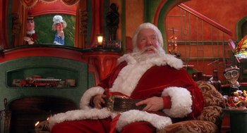 Movie still from “The Santa Clause 2” (2002), directed by Michael Lembeck – A man dressed as santa claus sitting in a chair; Medium shot, Low angle