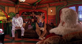 Movie still from “The Santa Clause 2” (2002), directed by Michael Lembeck – A man and a woman dressed up as a rabbit and santa clause; Wide shot, High angle