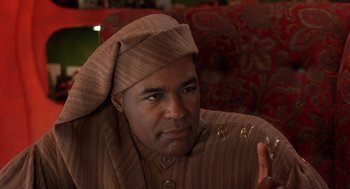 Movie still from “The Santa Clause 2” (2002), directed by Michael Lembeck – A man wearing a brown robe and a hat; Close Up shot, Low angle