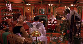 Movie still from “The Santa Clause 2” (2002), directed by Michael Lembeck – A man dressed as santa claus in a living room; Wide shot, High angle