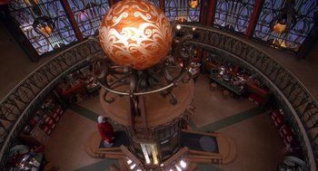 Movie still from “The Santa Clause 2” (2002), directed by Michael Lembeck – An overhead view of an ornate globe in a building; Extreme Wide shot, High angle