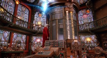 Movie still from “The Santa Clause 2” (2002), directed by Michael Lembeck – A man in a red suit standing in front of a machine; Wide shot, Low angle