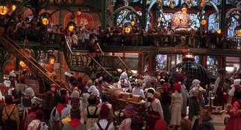 Movie still from “The Santa Clause 2” (2002), directed by Michael Lembeck – A group of people dressed in costumes in front of a building; Extreme Wide shot, High angle