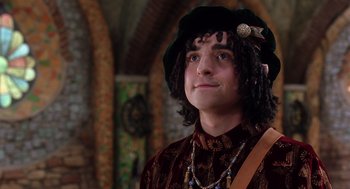 Movie still from “The Santa Clause 2” (2002), directed by Michael Lembeck – A man with a long curly hair wearing a hat; Close Up shot, Over the shoulder angle