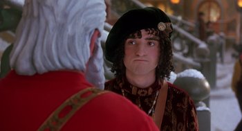 Movie still from “The Santa Clause 2” (2002), directed by Michael Lembeck – A young man in a hat and a red jacket is talking to an older man; Close Up shot, Over the shoulder angle
