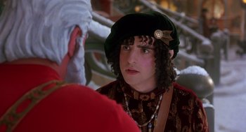 Movie still from “The Santa Clause 2” (2002), directed by Michael Lembeck – A young man wearing a green hat talking to an older man; Close Up shot, Over the shoulder angle