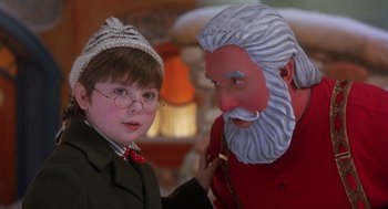 Movie still from “The Santa Clause 2” (2002), directed by Michael Lembeck – A young boy and an old man in a christmas scene; Close Up shot, Over the shoulder angle