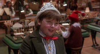 Movie still from “The Santa Clause 2” (2002), directed by Michael Lembeck – A young boy wearing a hat and a bow tie; Close Up shot, High angle