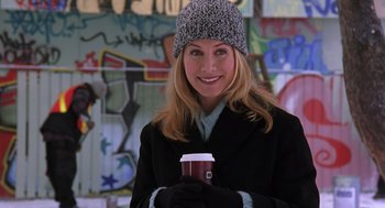 Movie still from “The Santa Clause 2” (2002), directed by Michael Lembeck – A woman holding a cup of coffee in her hands; Medium shot, Over the shoulder angle