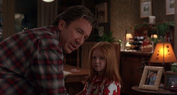 Movie still from “The Santa Clause 2” (2002), directed by Michael Lembeck – A man standing next to a little girl in a room; Medium shot, Over the shoulder angle