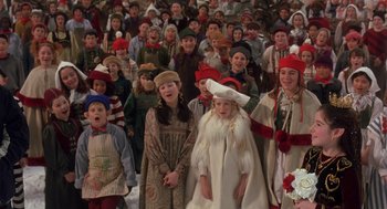 Movie still from “The Santa Clause 2” (2002), directed by Michael Lembeck – A large group of children dressed up for christmas; Medium shot, High angle