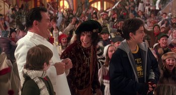 Movie still from “The Santa Clause 2” (2002), directed by Michael Lembeck – A group of people standing in front of a crowd of people; Medium shot, Over the shoulder angle