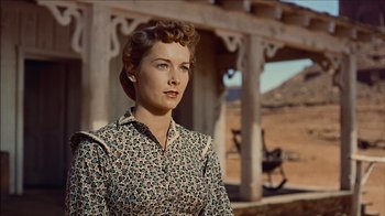 Movie still from “The Searchers” (1956), directed by John Ford – A woman standing in front of a building in the desert; Medium shot, Low angle