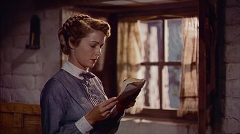 Movie still from “The Searchers” (1956), directed by John Ford – A young woman reading a book by a window; Close Up shot, Low angle