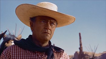 Movie still from “The Searchers” (1956), directed by John Ford – A man wearing a hat and a neck tie; Close Up shot, Low angle