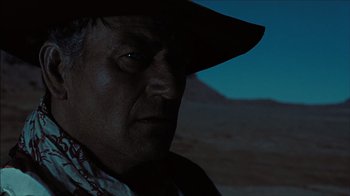 Movie still from “The Searchers” (1956), directed by John Ford – A person wearing a cowboy hat; Close Up shot, Low angle