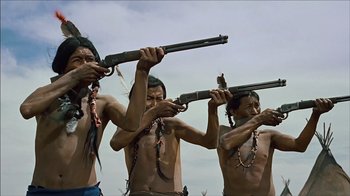 Movie still from “The Searchers” (1956), directed by John Ford – A group of men holding guns in their hands; Medium shot, Low angle