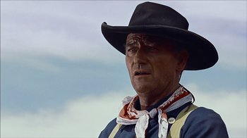 Movie still from “The Searchers” (1956), directed by John Ford – A man wearing a cowboy hat and neck scarf; Close Up shot, Low angle