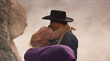Movie still from “The Searchers” (1956), directed by John Ford – A man and a child are hugging each other; Medium shot, Low angle