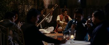 Movie still from “The Second Best Exotic Marigold Hotel” (2015), directed by John Madden – A group of people sitting around a table; Wide shot, Over the shoulder angle