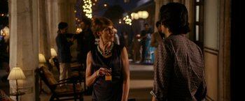 Movie still from “The Second Best Exotic Marigold Hotel” (2015), directed by John Madden – A woman in a black dress is talking to another woman; Medium shot, Over the shoulder angle