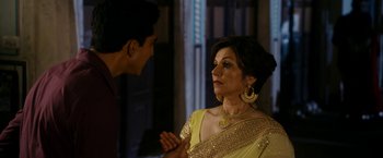Movie still from “The Second Best Exotic Marigold Hotel” (2015), directed by John Madden – A man and a woman in a yellow sari talking to each other; Medium shot, Over the shoulder angle
