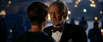 Movie still from “The Second Best Exotic Marigold Hotel” (2015), directed by John Madden – An older man wearing a tuxedo and a bow tie; Close Up shot, Over the shoulder angle