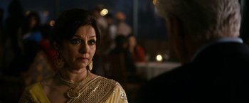 Movie still from “The Second Best Exotic Marigold Hotel” (2015), directed by John Madden – A person wearing a dress; Close Up shot, Over the shoulder angle