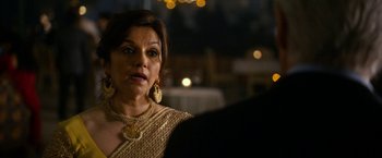 Movie still from “The Second Best Exotic Marigold Hotel” (2015), directed by John Madden – A person wearing a necklace; Close Up shot, Over the shoulder angle