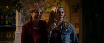 Movie still from “The Second Best Exotic Marigold Hotel” (2015), directed by John Madden – Two women standing next to each other in front of a building; Medium shot, Low angle