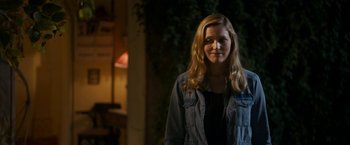 Movie still from “The Second Best Exotic Marigold Hotel” (2015), directed by John Madden – A woman standing in the dark wearing a jean jacket; Medium shot, Over the shoulder angle