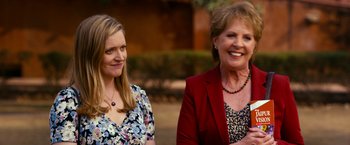 Movie still from “The Second Best Exotic Marigold Hotel” (2015), directed by John Madden – Two women standing next to each other on a sidewalk; Medium shot, Over the shoulder angle