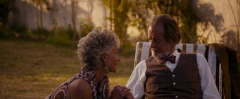 Movie still from “The Second Best Exotic Marigold Hotel” (2015), directed by John Madden – An older man and woman sitting on a bench; Medium shot, Over the shoulder angle