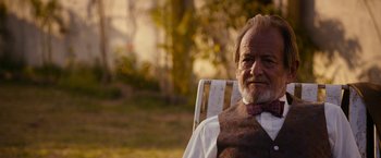 Movie still from “The Second Best Exotic Marigold Hotel” (2015), directed by John Madden – An older man sitting in a lawn chair outside; Close Up shot, Over the shoulder angle