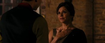 Movie still from “The Second Best Exotic Marigold Hotel” (2015), directed by John Madden – A woman standing next to a man with her hands over her chest; Close Up shot, Over the shoulder angle