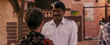 Movie still from “The Second Best Exotic Marigold Hotel” (2015), directed by John Madden – A man in a white shirt talking to a woman; Medium shot, Over the shoulder angle