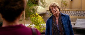 Movie still from “The Second Best Exotic Marigold Hotel” (2015), directed by John Madden – An older woman standing in front of another woman; Close Up shot, Over the shoulder angle