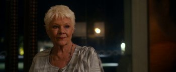 Movie still from “The Second Best Exotic Marigold Hotel” (2015), directed by John Madden – An older woman with white hair is posing for a picture; Close Up shot, Over the shoulder angle