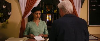Movie still from “The Second Best Exotic Marigold Hotel” (2015), directed by John Madden – A man and a woman are sitting at a table; Medium shot, Over the shoulder angle