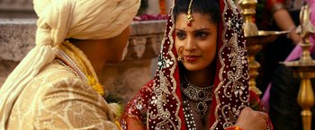Movie still from “The Second Best Exotic Marigold Hotel” (2015), directed by John Madden – A woman in a red and white dress and a man in a white turban; Close Up shot, Over the shoulder angle