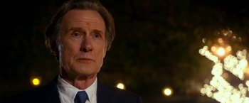 Movie still from “The Second Best Exotic Marigold Hotel” (2015), directed by John Madden – An older man wearing a suit and tie; Close Up shot, Over the shoulder angle