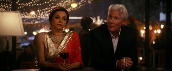 Movie still from “The Second Best Exotic Marigold Hotel” (2015), directed by John Madden – An older man and a woman sitting at a bar; Medium shot, Over the shoulder angle