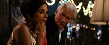Movie still from “The Second Best Exotic Marigold Hotel” (2015), directed by John Madden – A man and a woman sitting next to each other at a table; Close Up shot, Over the shoulder angle