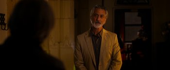 Movie still from “The Second Best Exotic Marigold Hotel” (2015), directed by John Madden – An older man wearing a suit standing in front of a mirror; Close Up shot, Over the shoulder angle