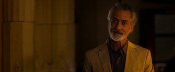 Movie still from “The Second Best Exotic Marigold Hotel” (2015), directed by John Madden – An older man with a beard and a suit; Close Up shot, Over the shoulder angle