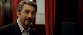 Movie still from “The Secret in Their Eyes” (2009), directed by Juan José Campanella – A person wearing a suit and tie; Close Up shot, Over the shoulder angle